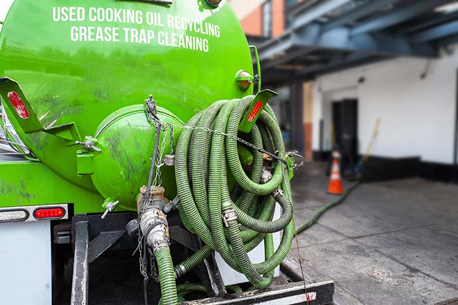 a vacuum truck pumping out a large underground grease trap in Buffalo Grove IL